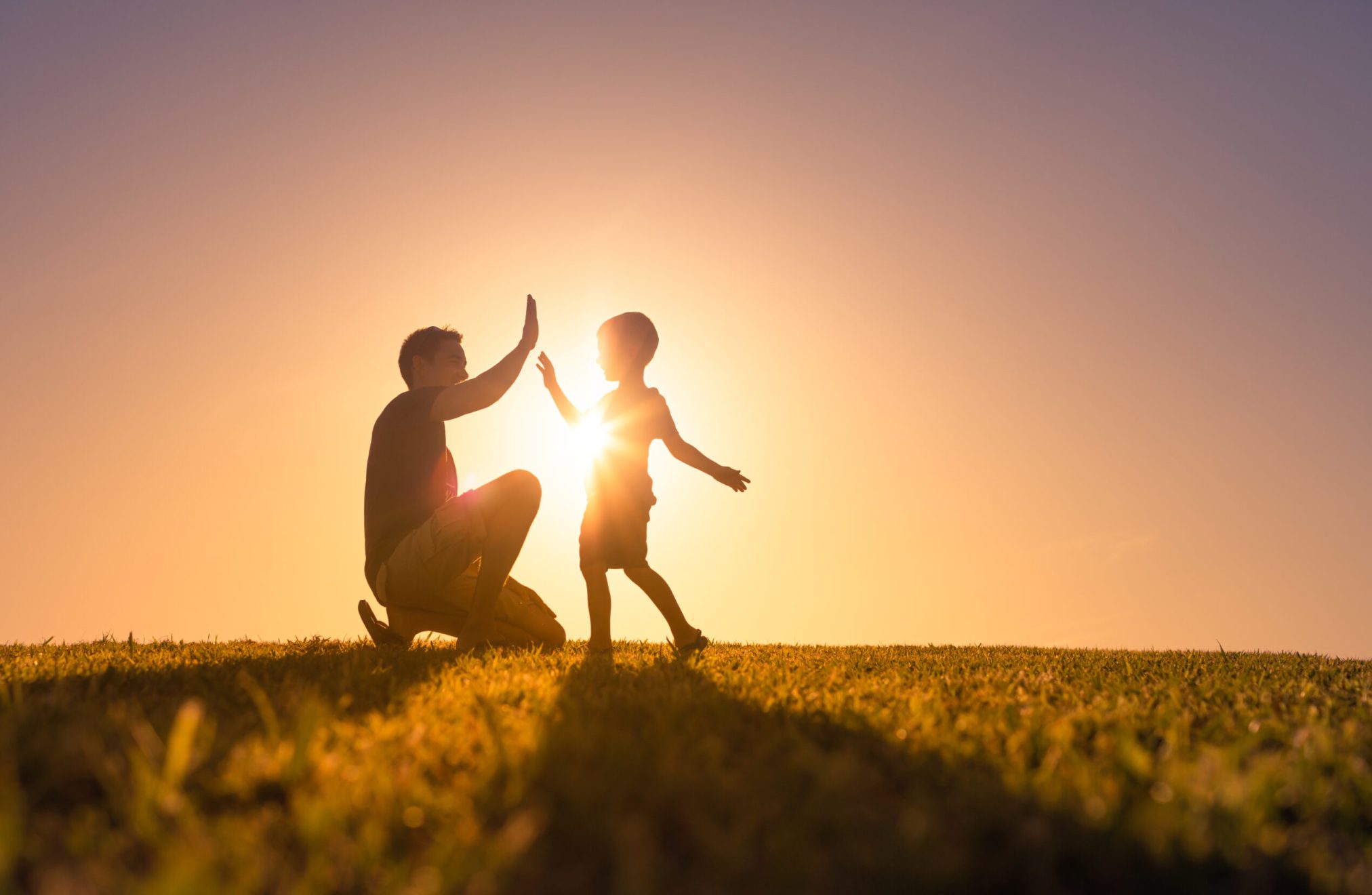 Happy father playing with his son giving him a high five. Father Happy father playing with his son giving him a high five. Father